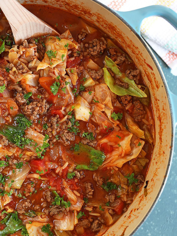 Overhead close up of Stuffed Cabbage Soup with wooden spoon.