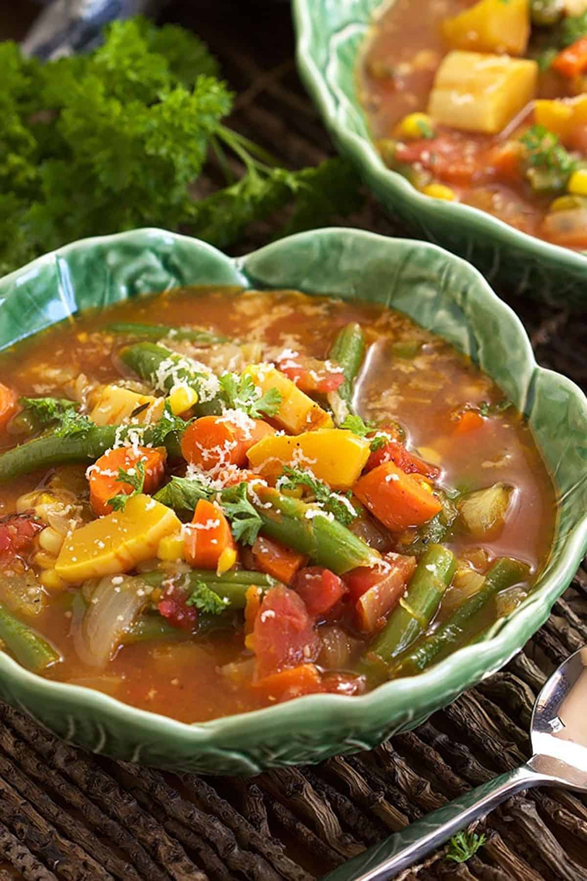 Veggies are piled high in a rich brown broth. 