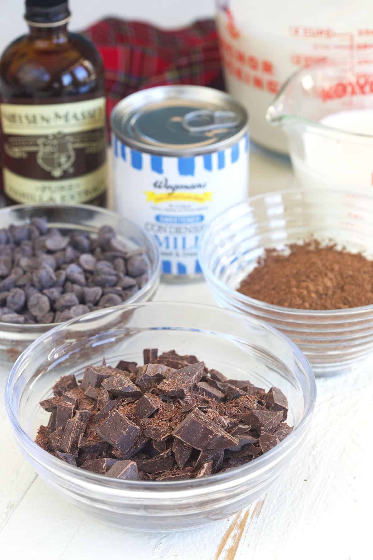 The ingredients for Crockpot hot chocolate are placed on a white surface. 