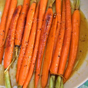 Carrots are cooking in a skillet.