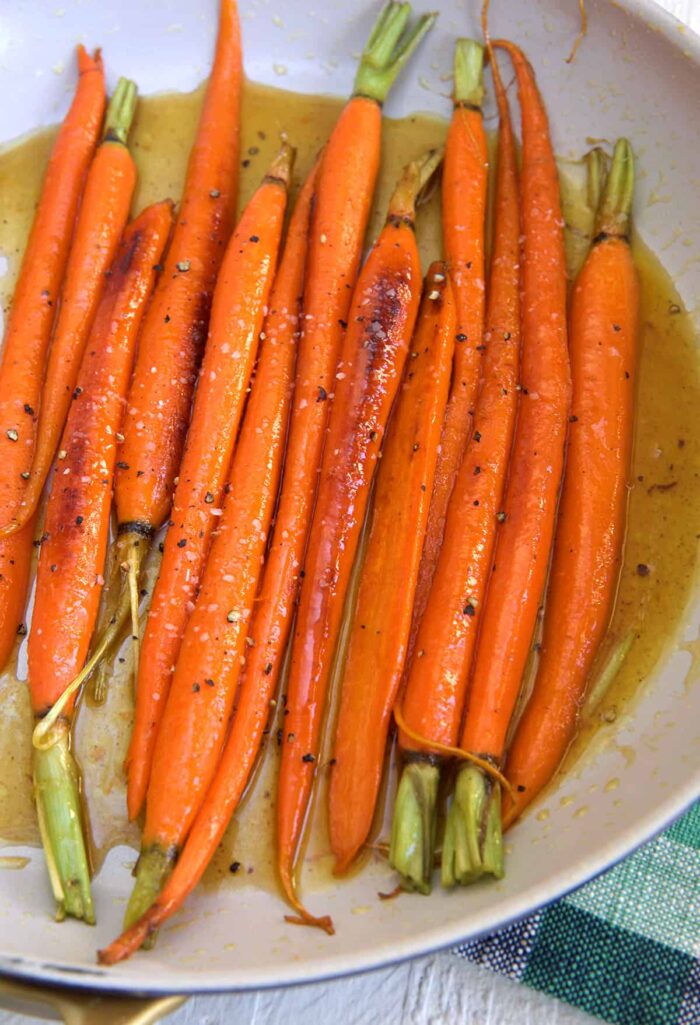 Carrots are cooking in a skillet.