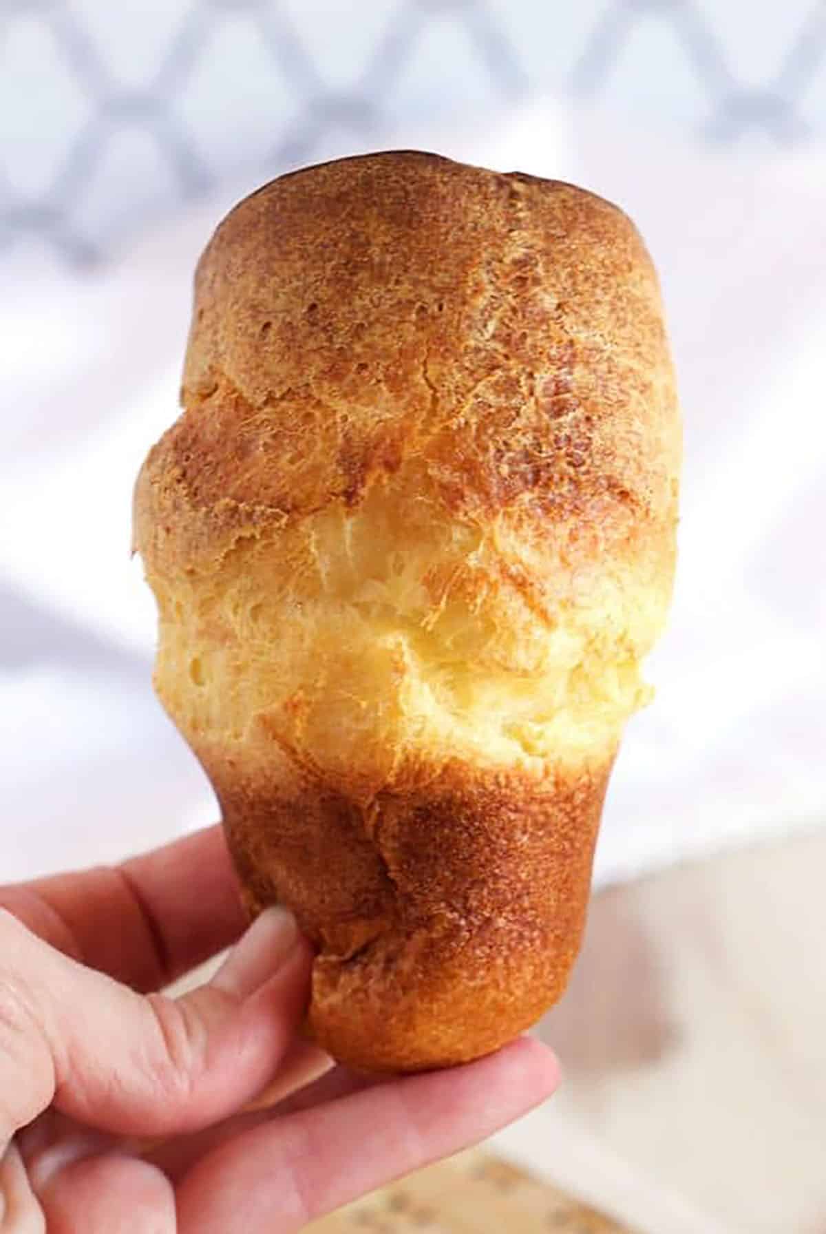 A hand holding a popover