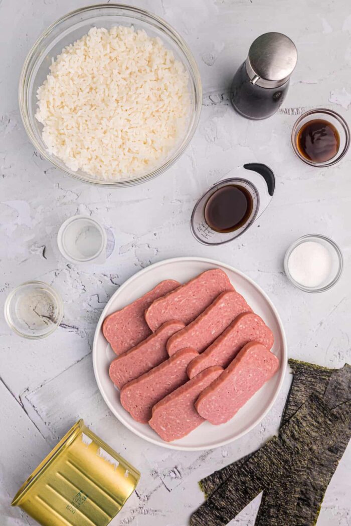 The ingredients for spam musubi are placed on a white countertop. 