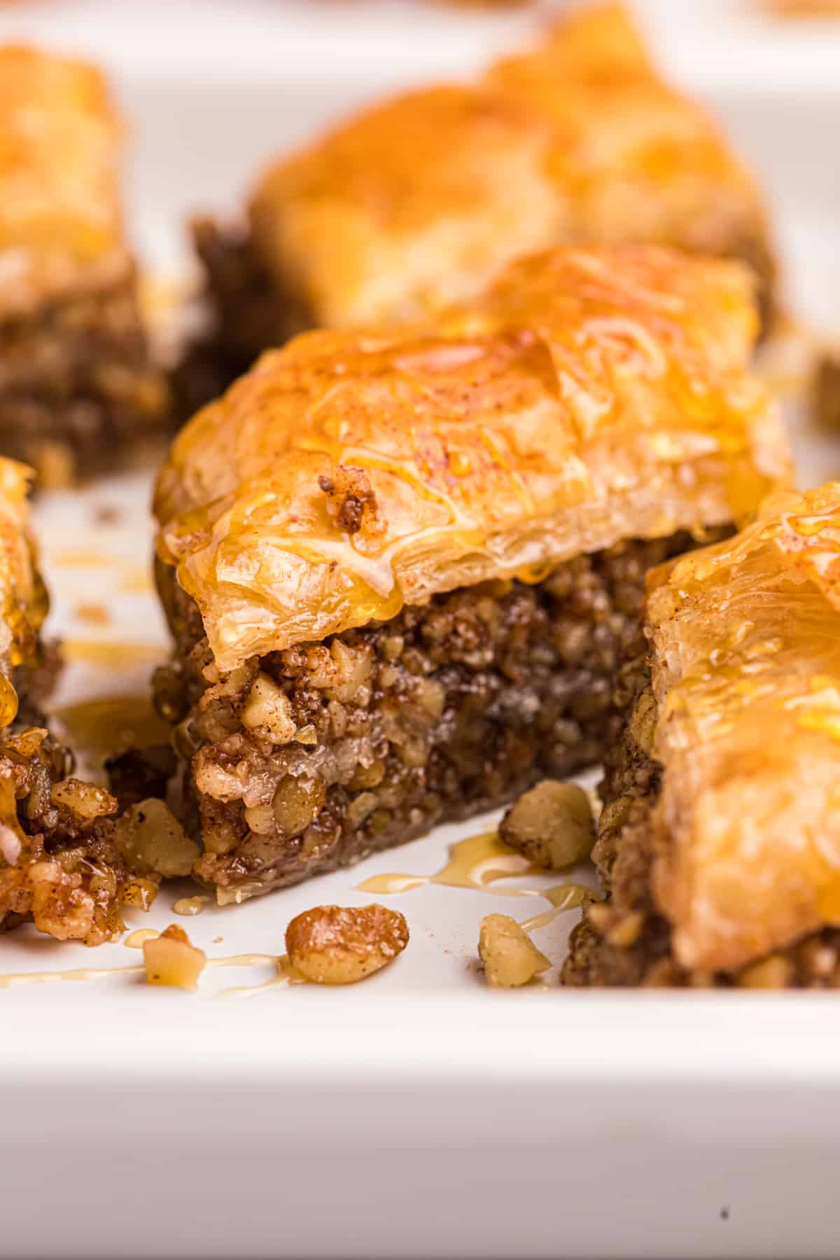 Several pieces of baklava are placed on a white plate.