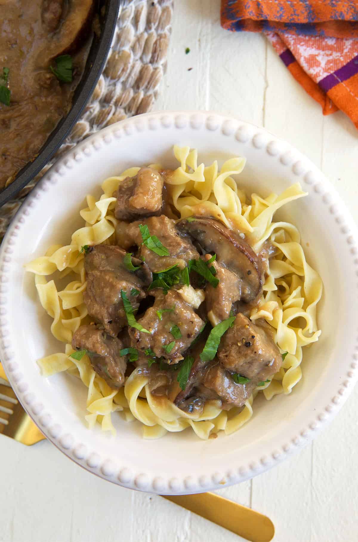 Egg noodles are topped with gravy coated beef tips.