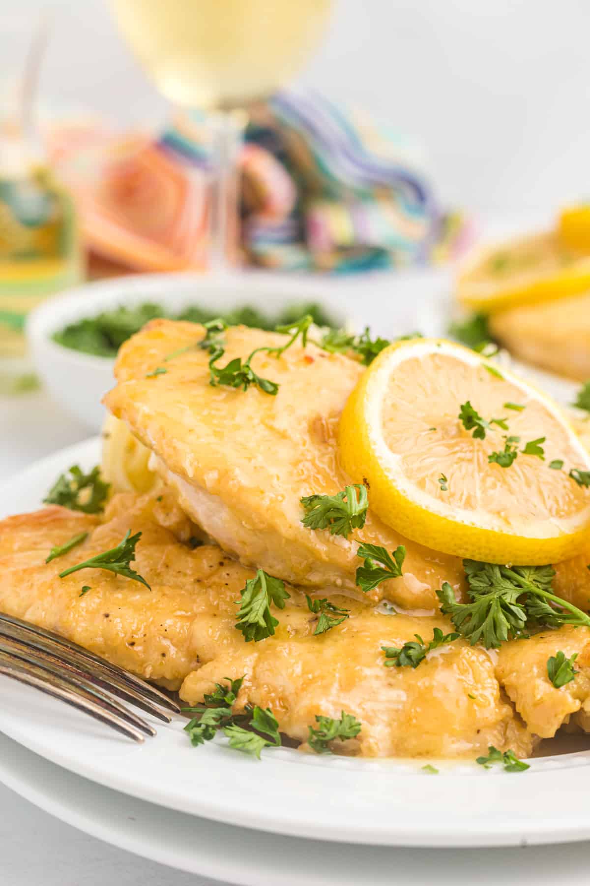 A serving of chicken francese is presented on a white plate.