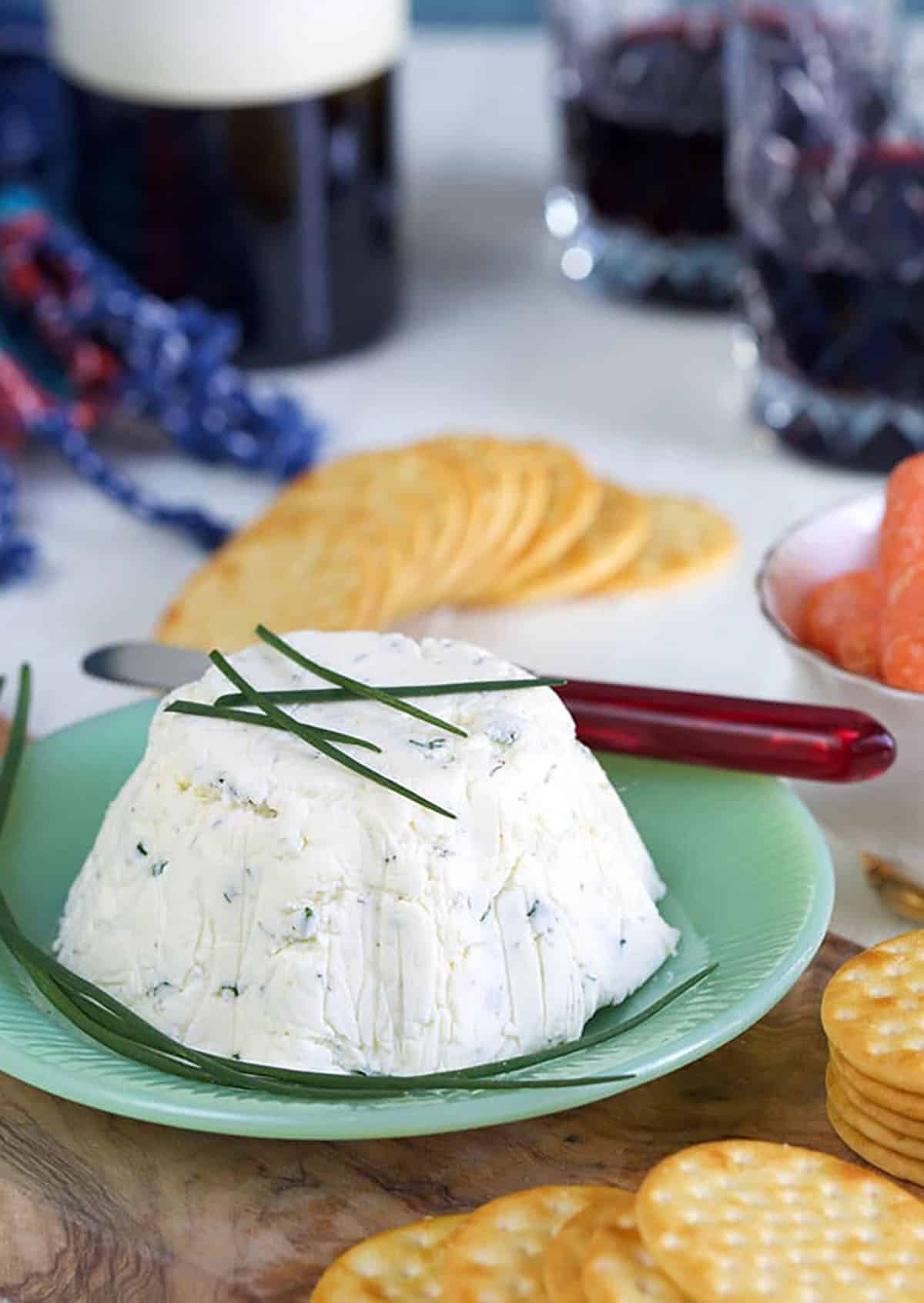 Boursin cheese is garnished with fresh chives.
