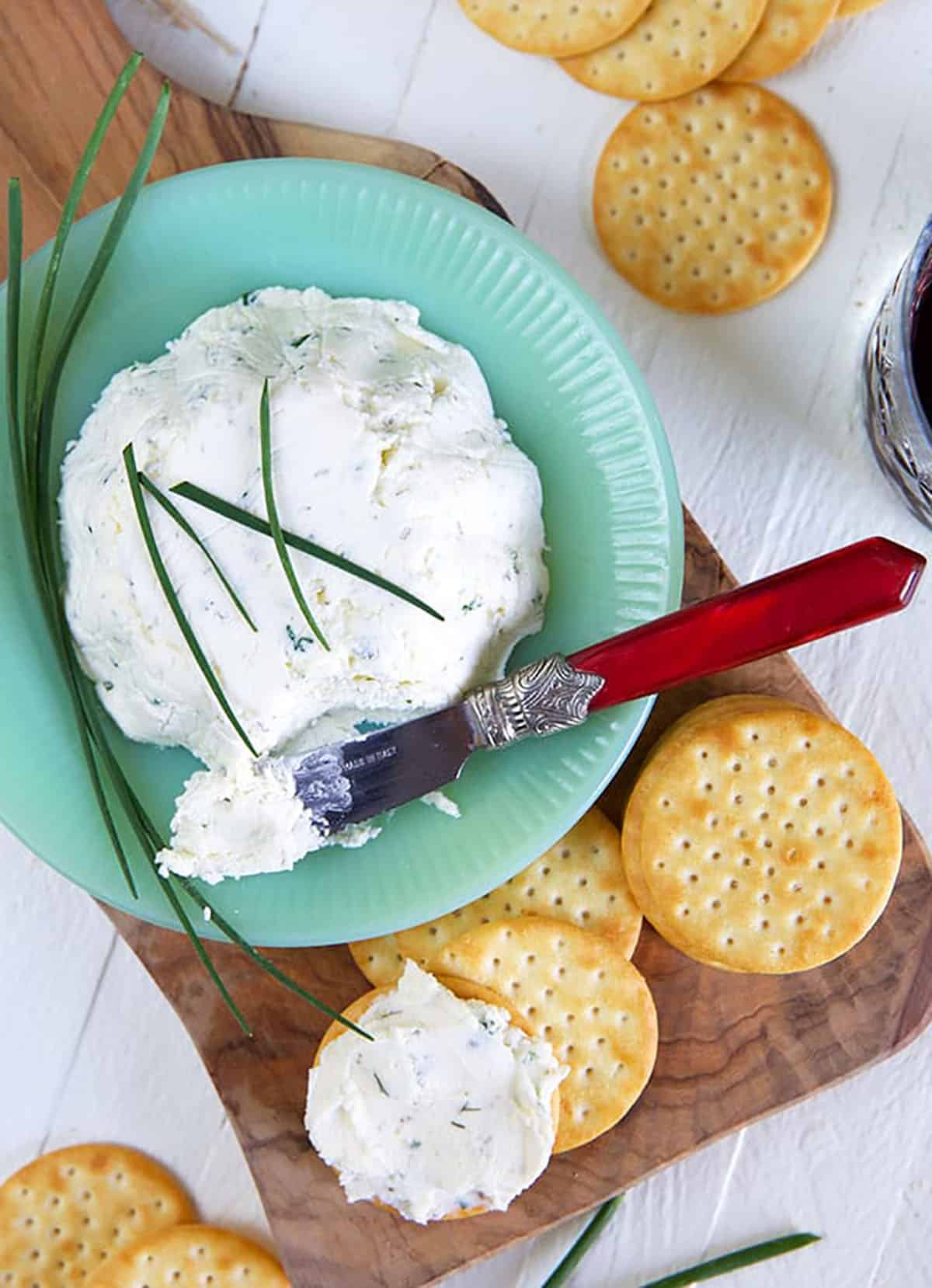 A blue bowl contains a large serving of Boursin cheese.
