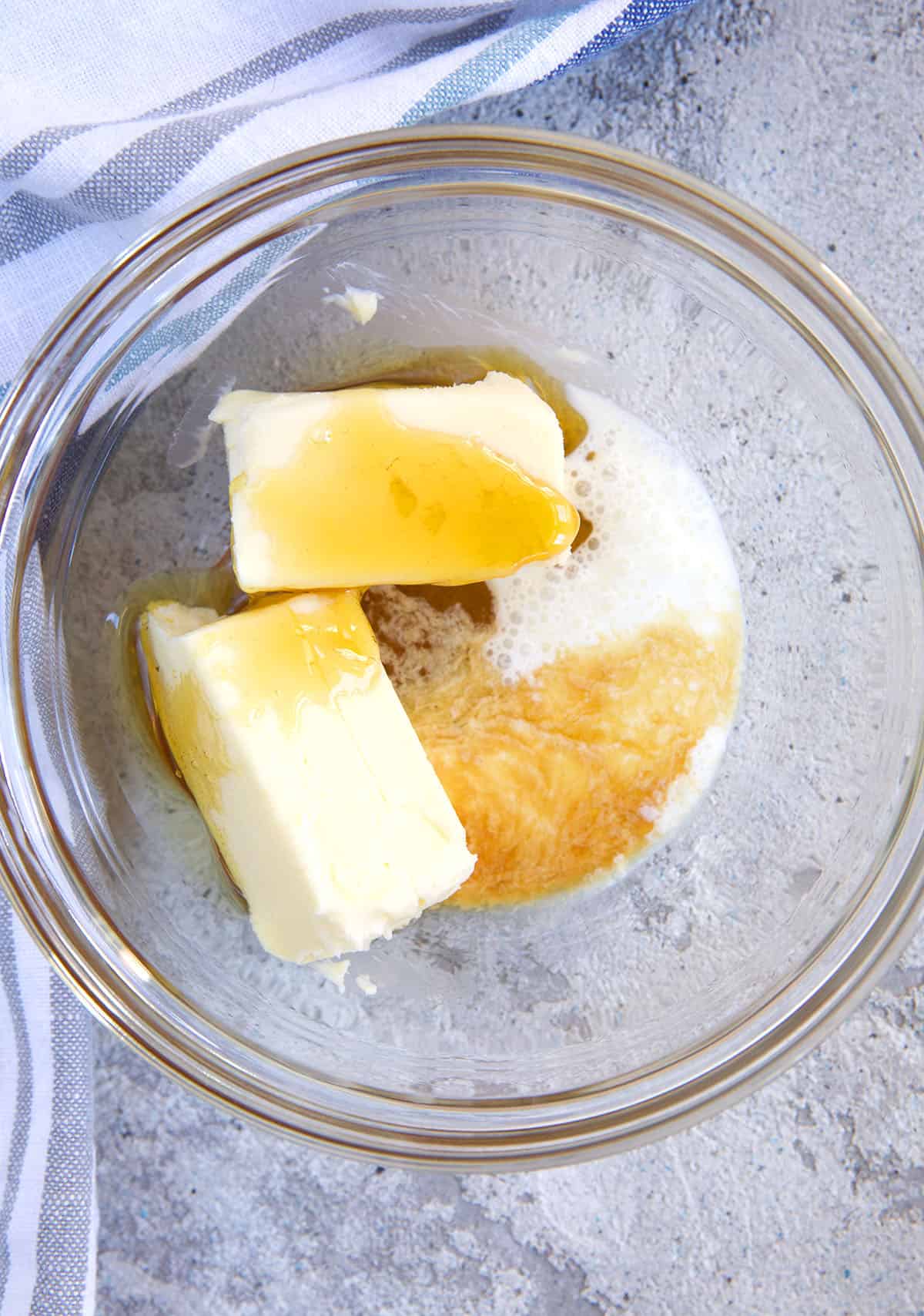 The ingredients for honey butter are placed in a glass bowl. 
