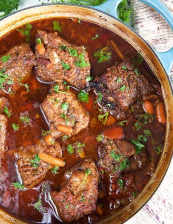 Short Ribs in a blue dutch oven.