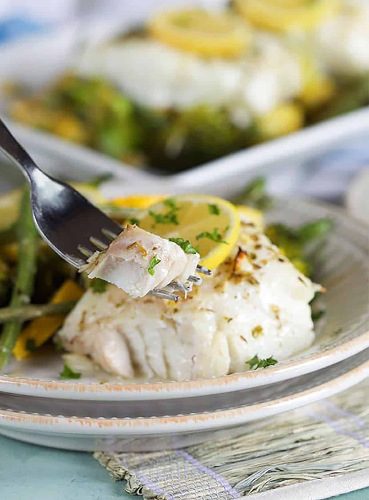 Cod filet with a bite on a fork.