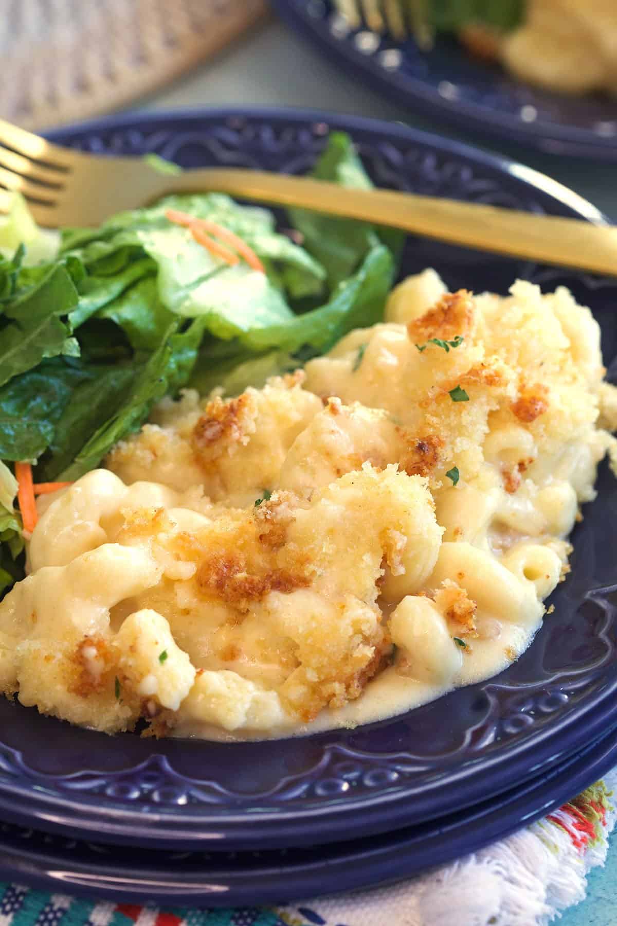 Homemade Mac and cheese on a blue plate with a garden salad.