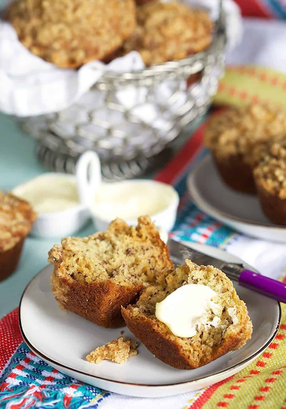 Banana Bread Muffins on a plate with a pat of butter.