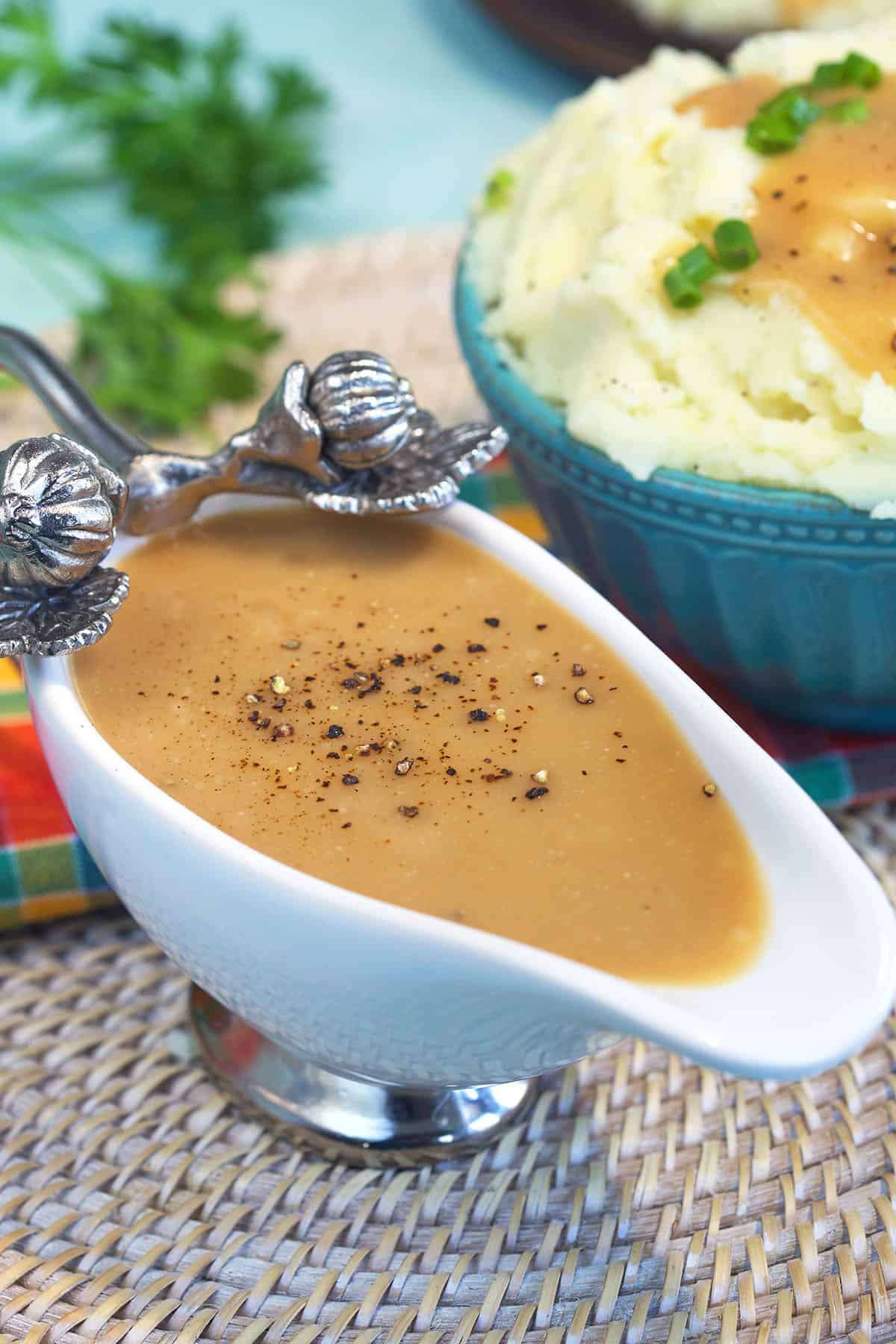 Brown gravy is topped with coarsley ground black pepper.