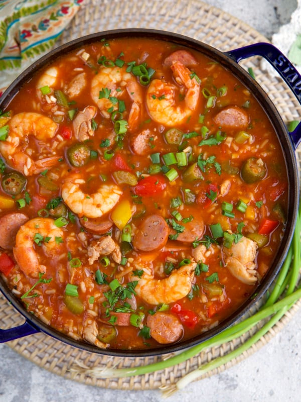 A large black pot is filled with Jambalaya.