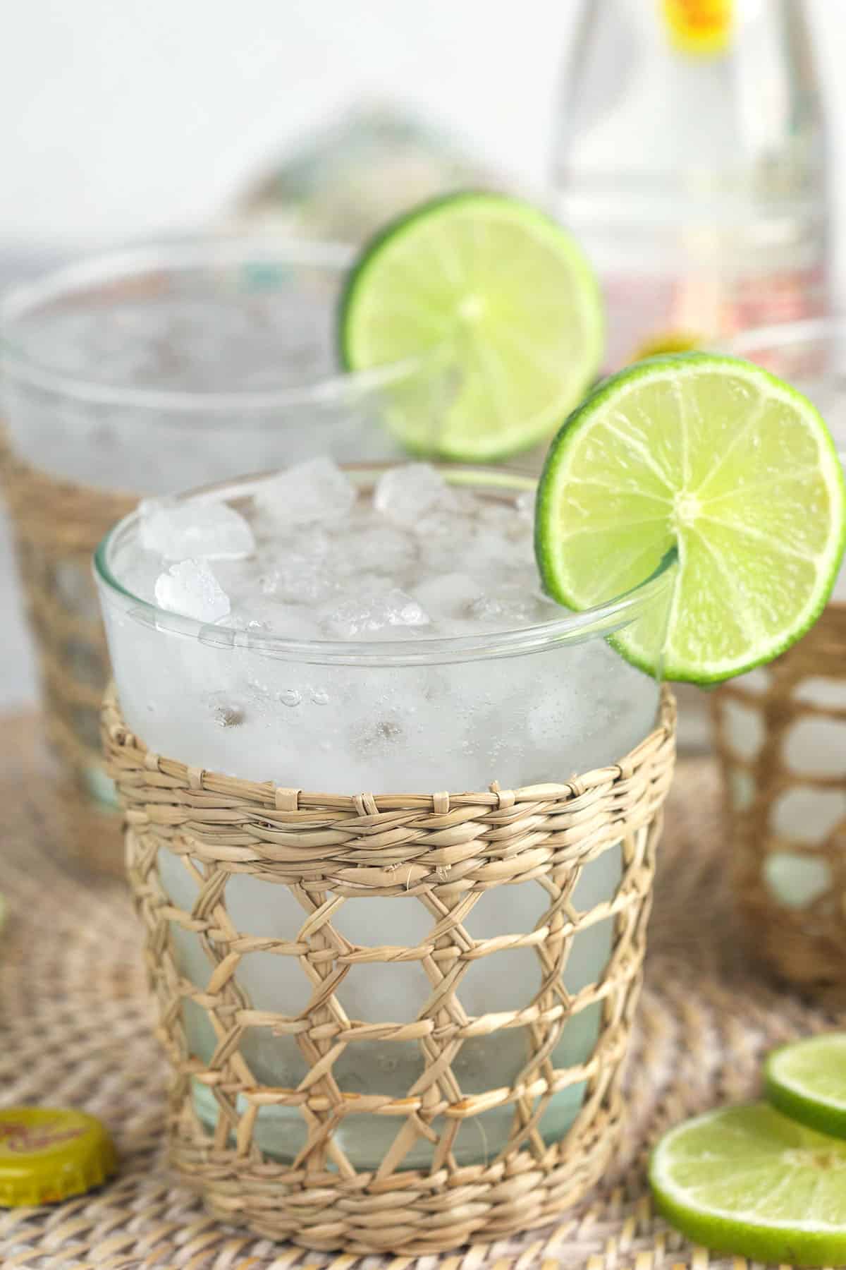 Limes are used as garnishes on the rims of several glasses.