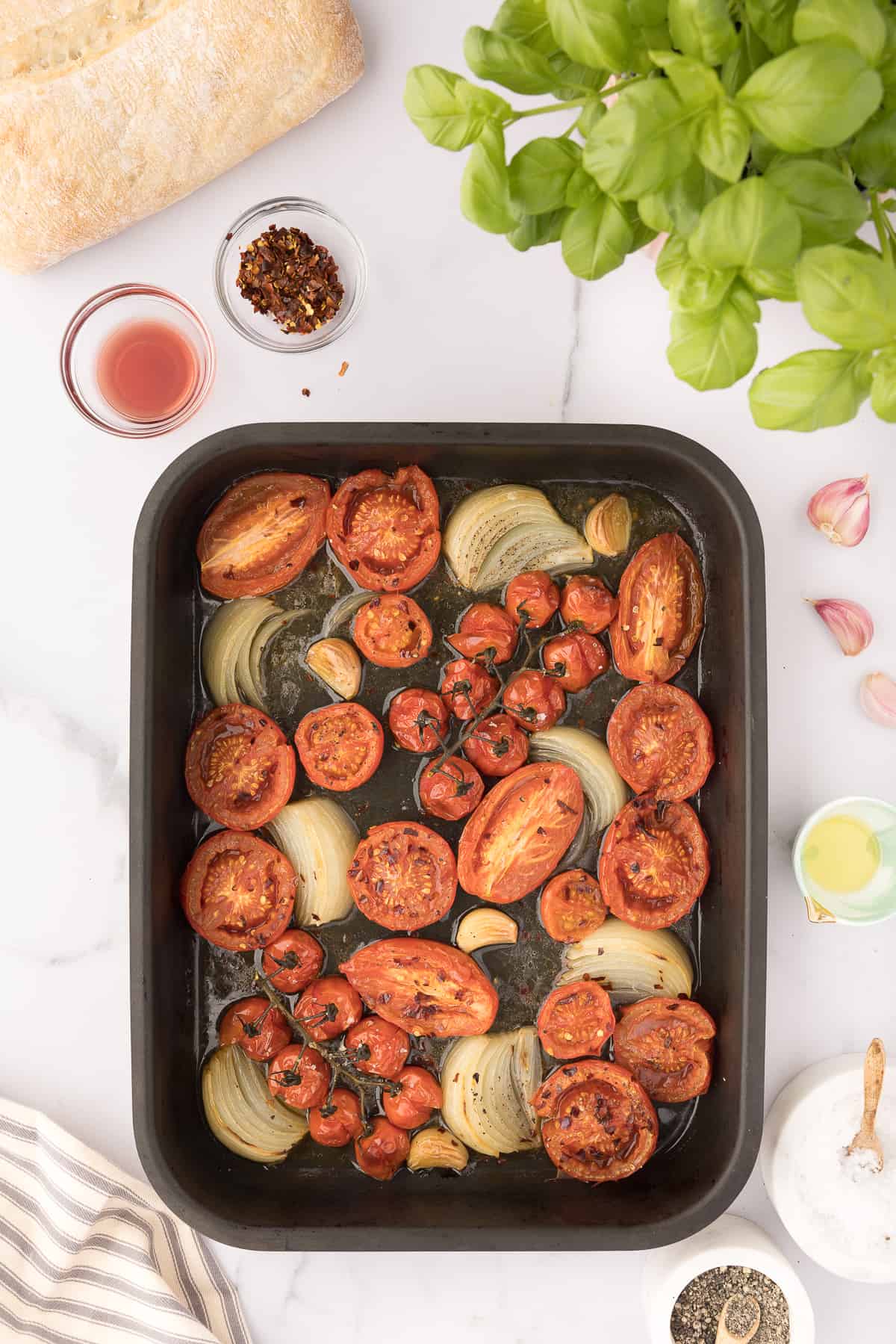 A baking sheet is filled with roasted veggies. 