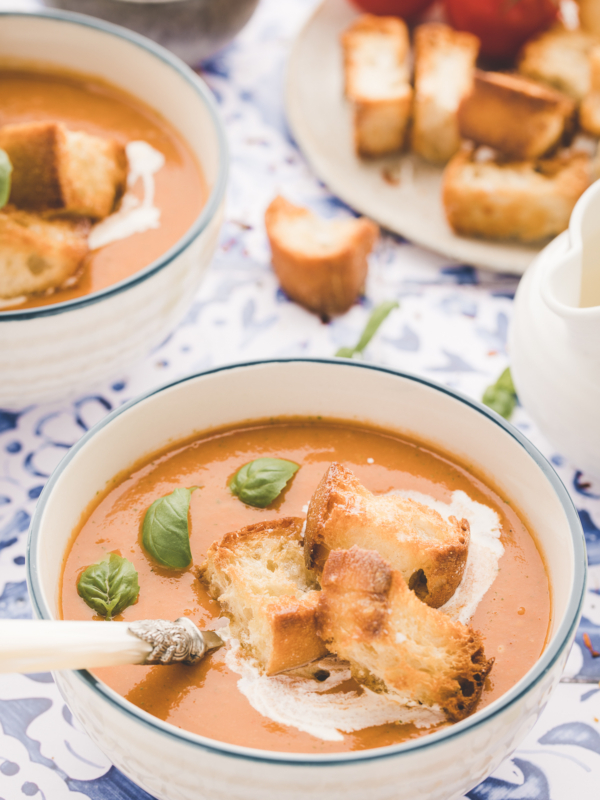 A white bowl is filled with soup.