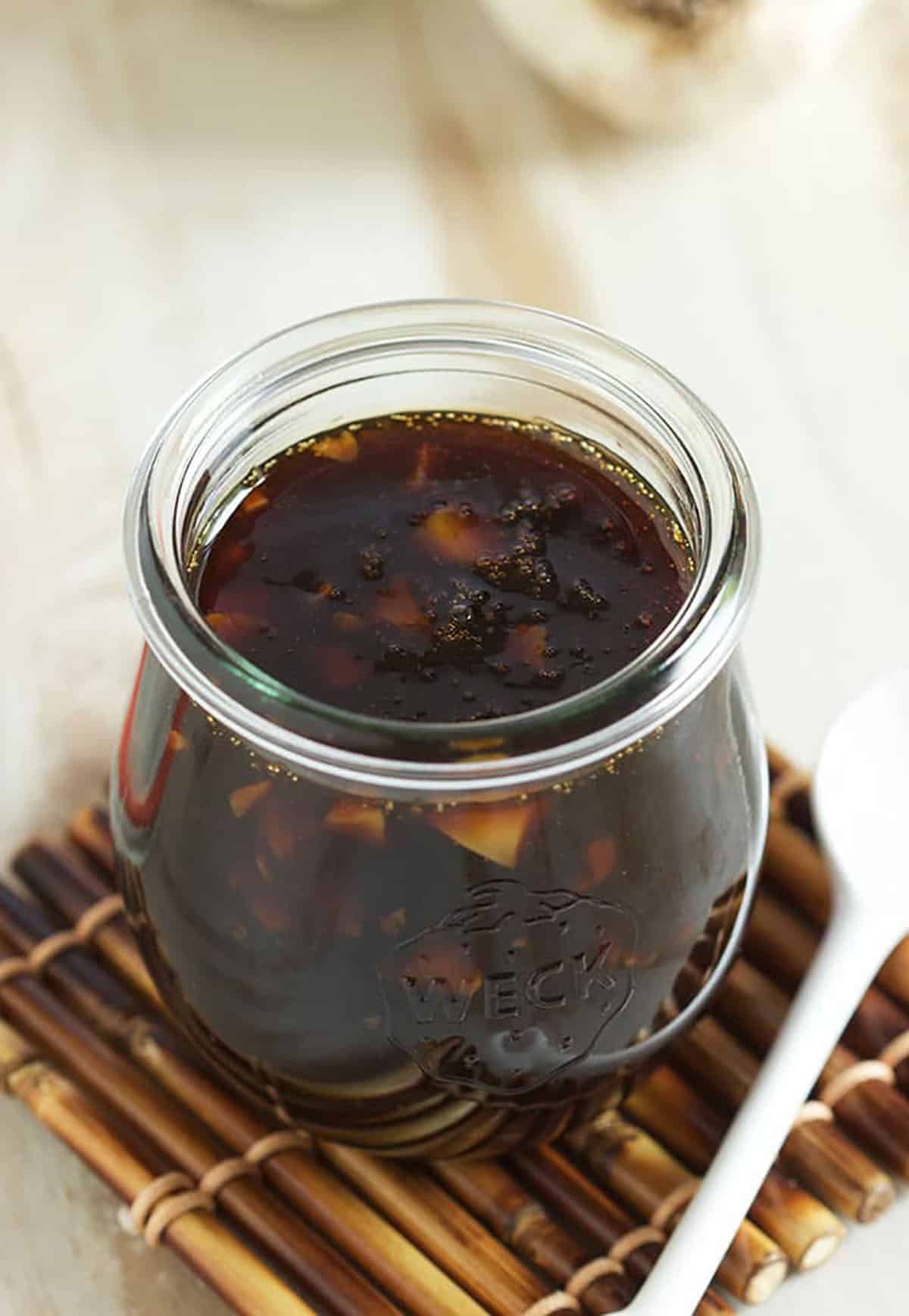 dark teriyaki sauce in a small jar.