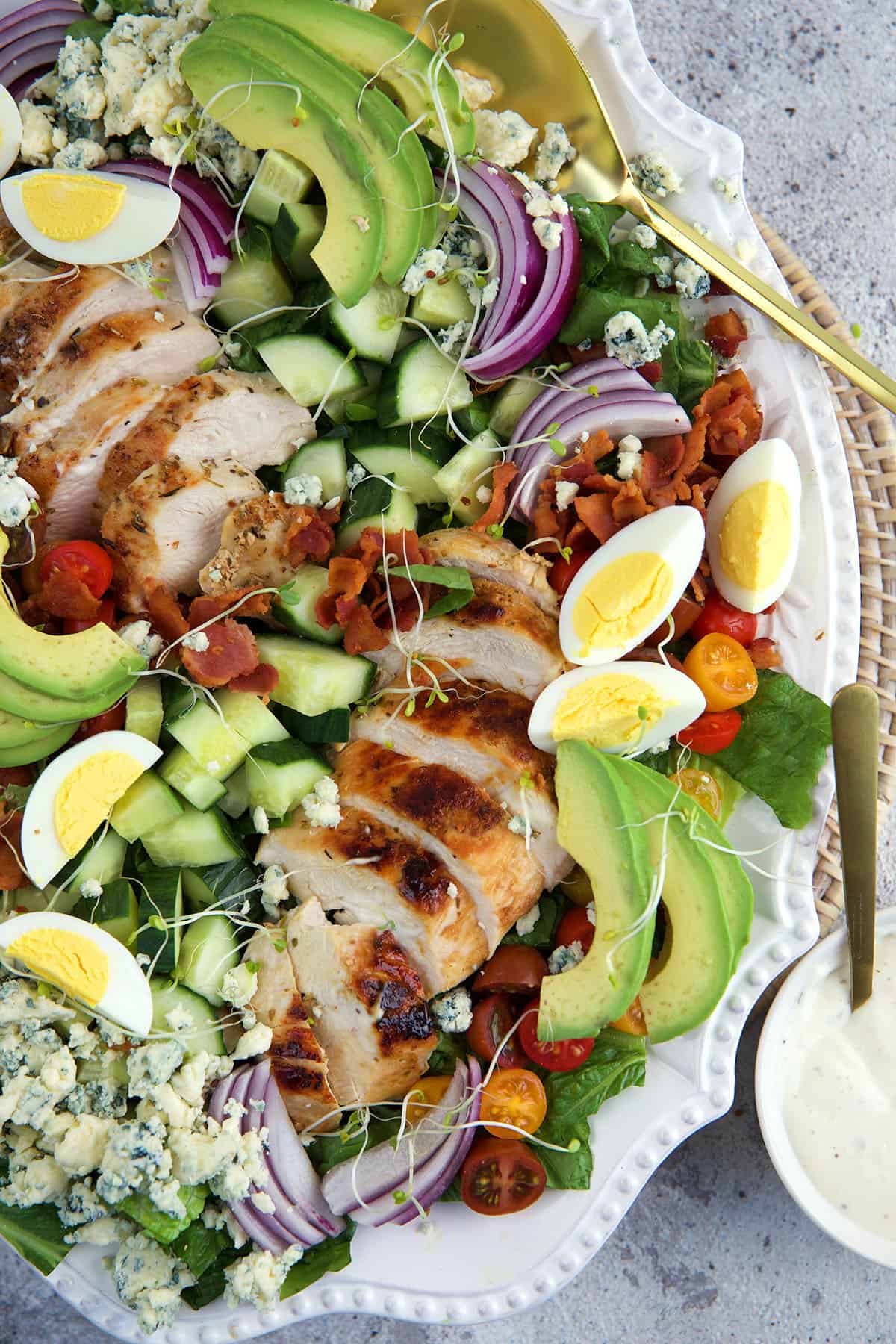 Eggs, avocado, chicken and more garnished a bed of greens.