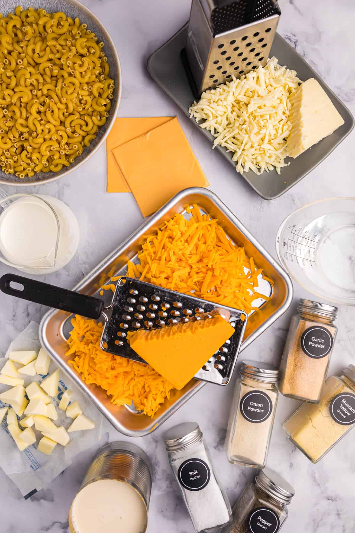 The ingredients for Crockpot mac and cheese are presented on a surface. 