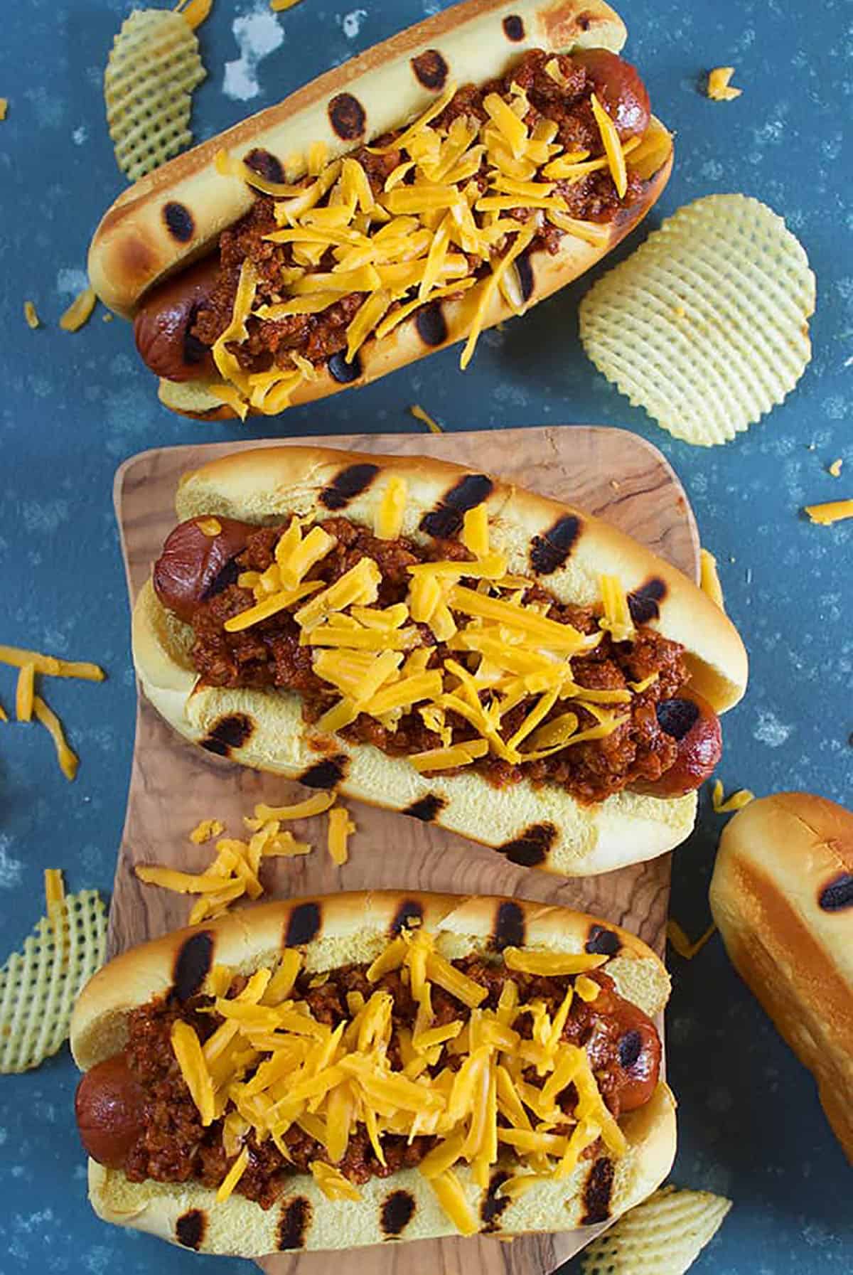 Overhead shot of three chili cheese dogs