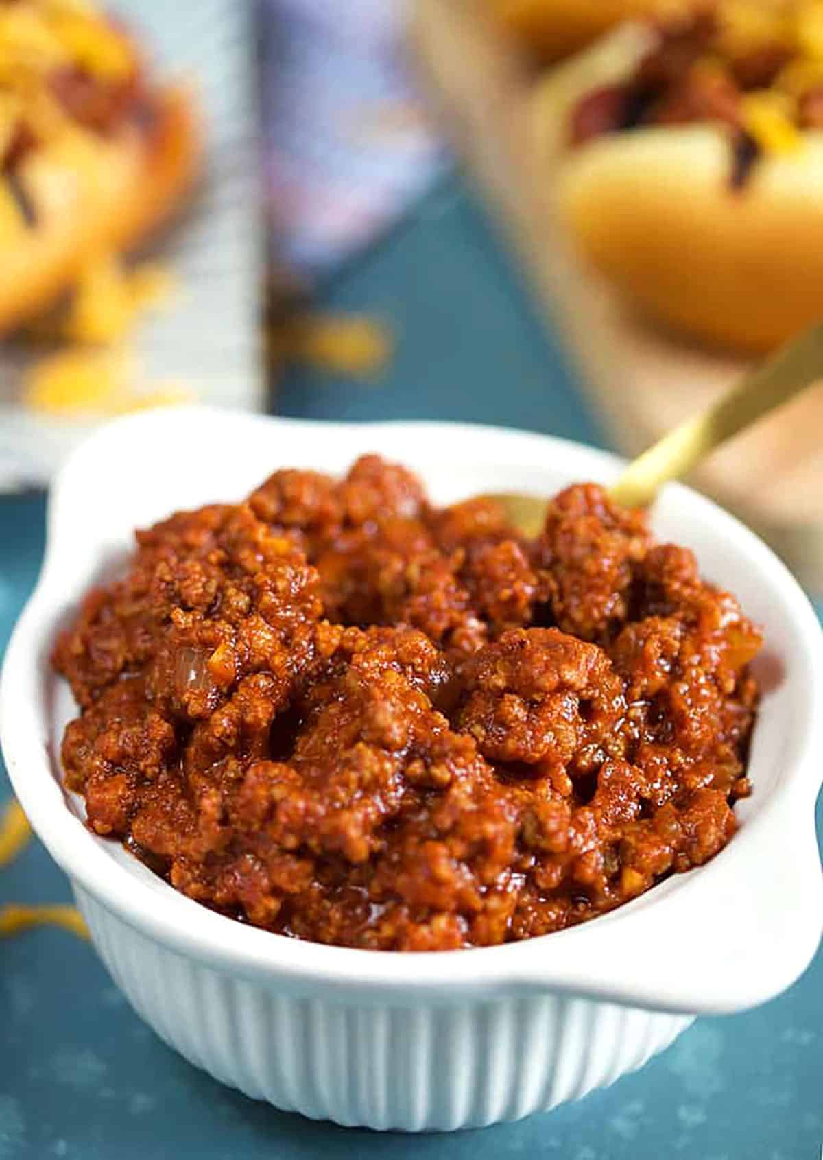 The BEST Hot Dog Chili Sauce in a white bowl on a blue background