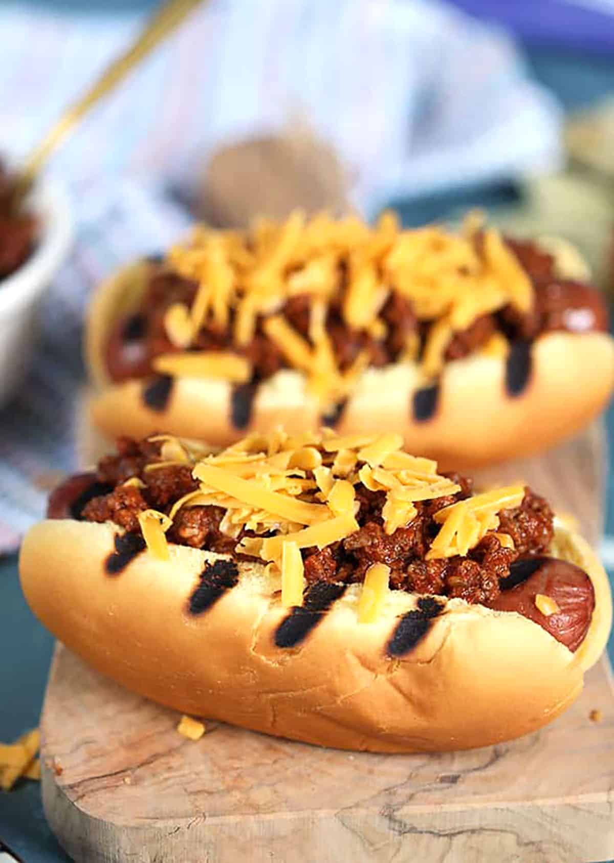 Chili Cheese Dogs on a wooden board