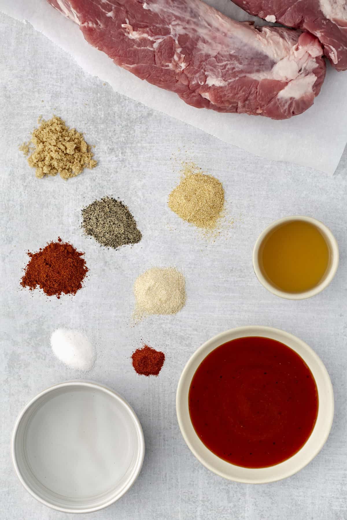 The ingredients for pulled pork are placed on a white surface.