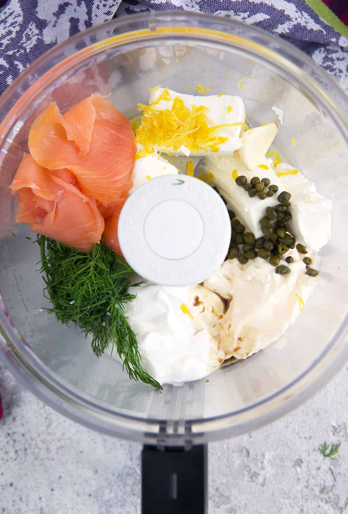 The ingredients for smoked salmon dip are placed in a food processor. 