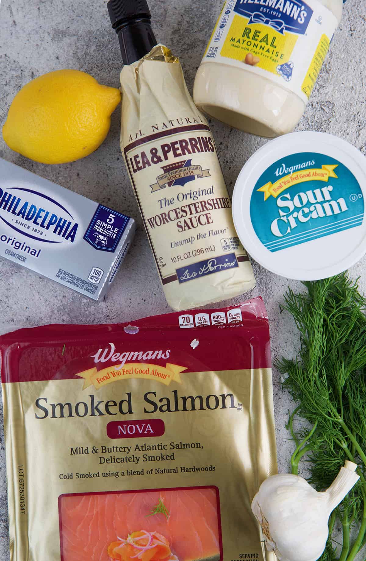The ingredients for smoked salmon dip are placed on a white surface.