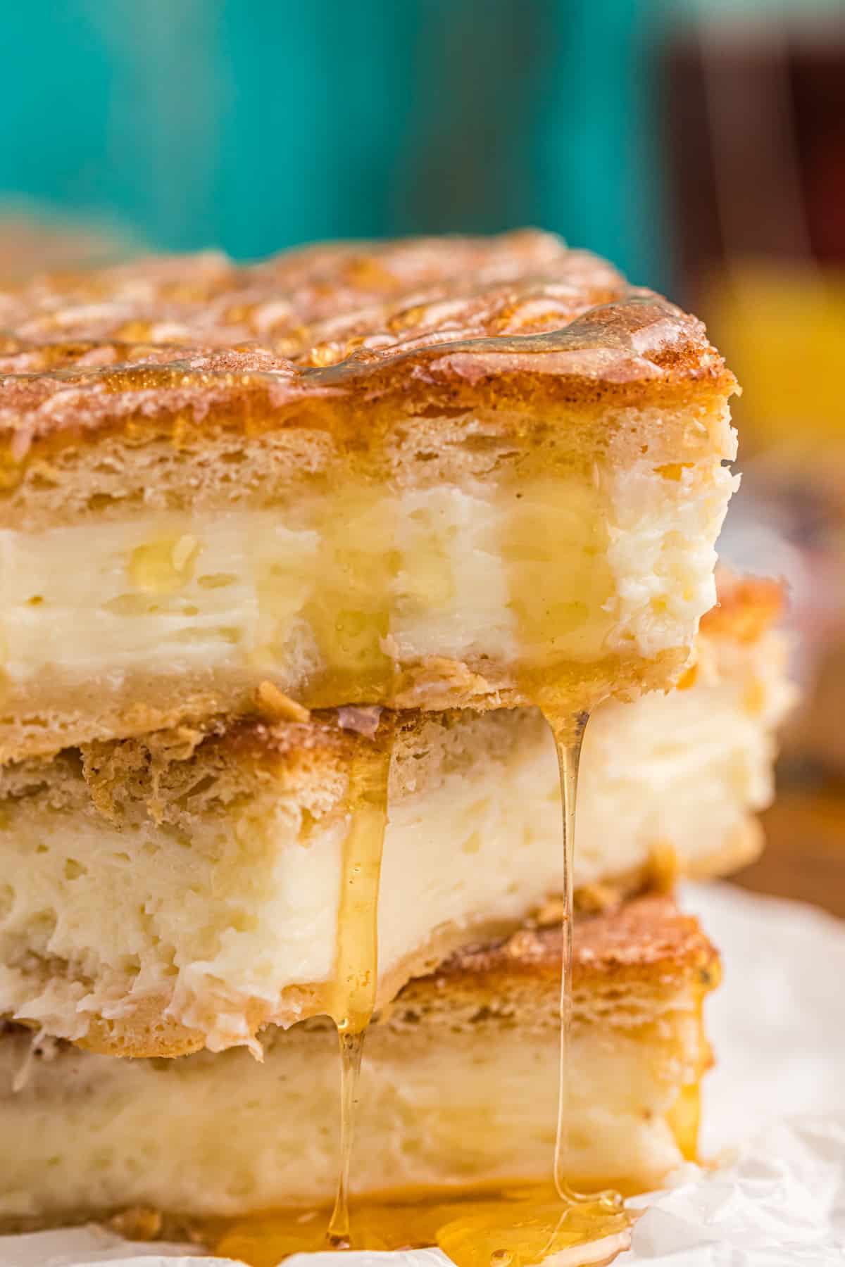 Sopapilla cheesecake bars are drizzled with honey.