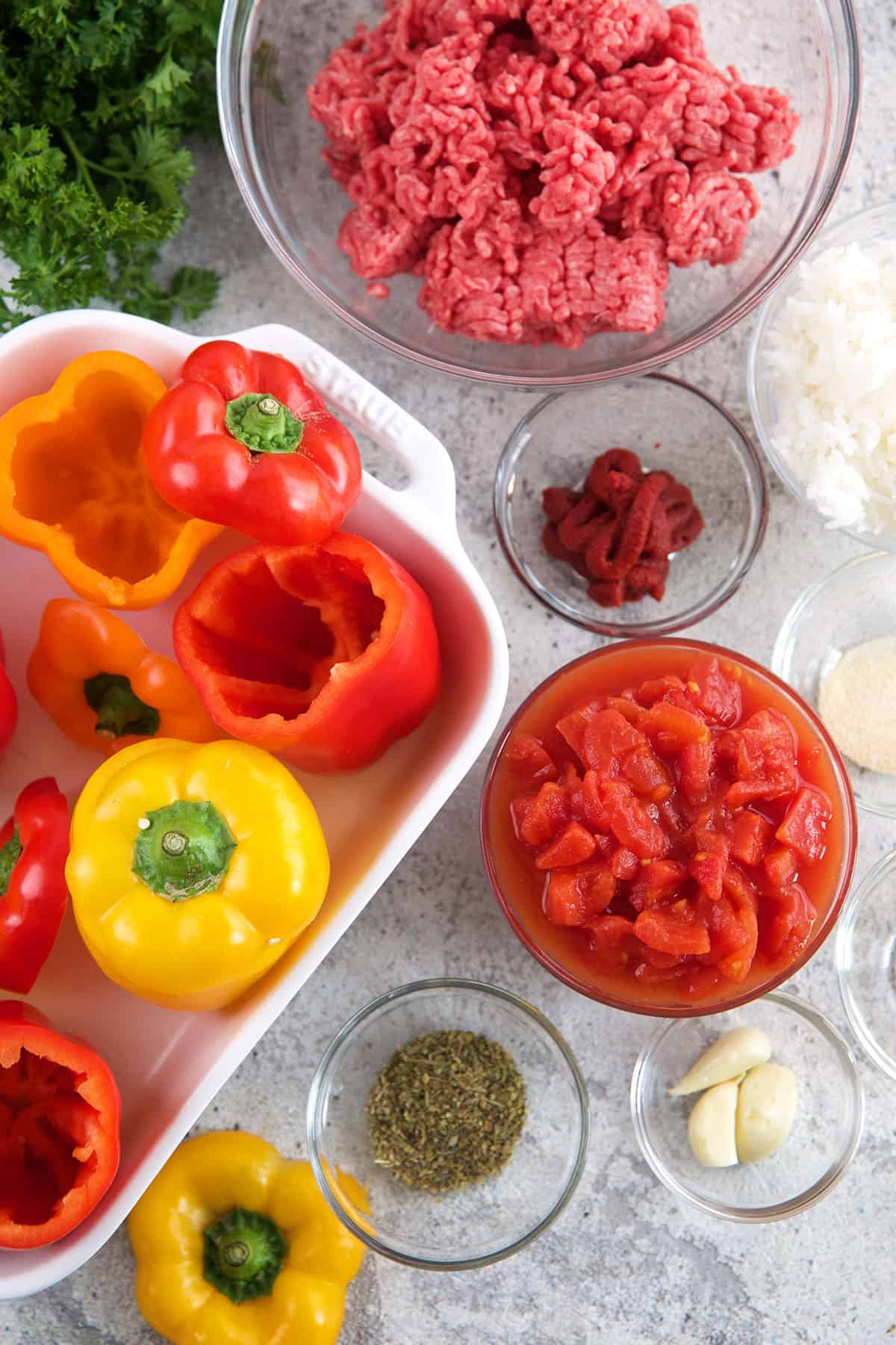 The ingredients for stuffed bell peppers are placed on a surface.