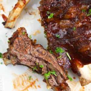 Ribs are placed on a white plate.