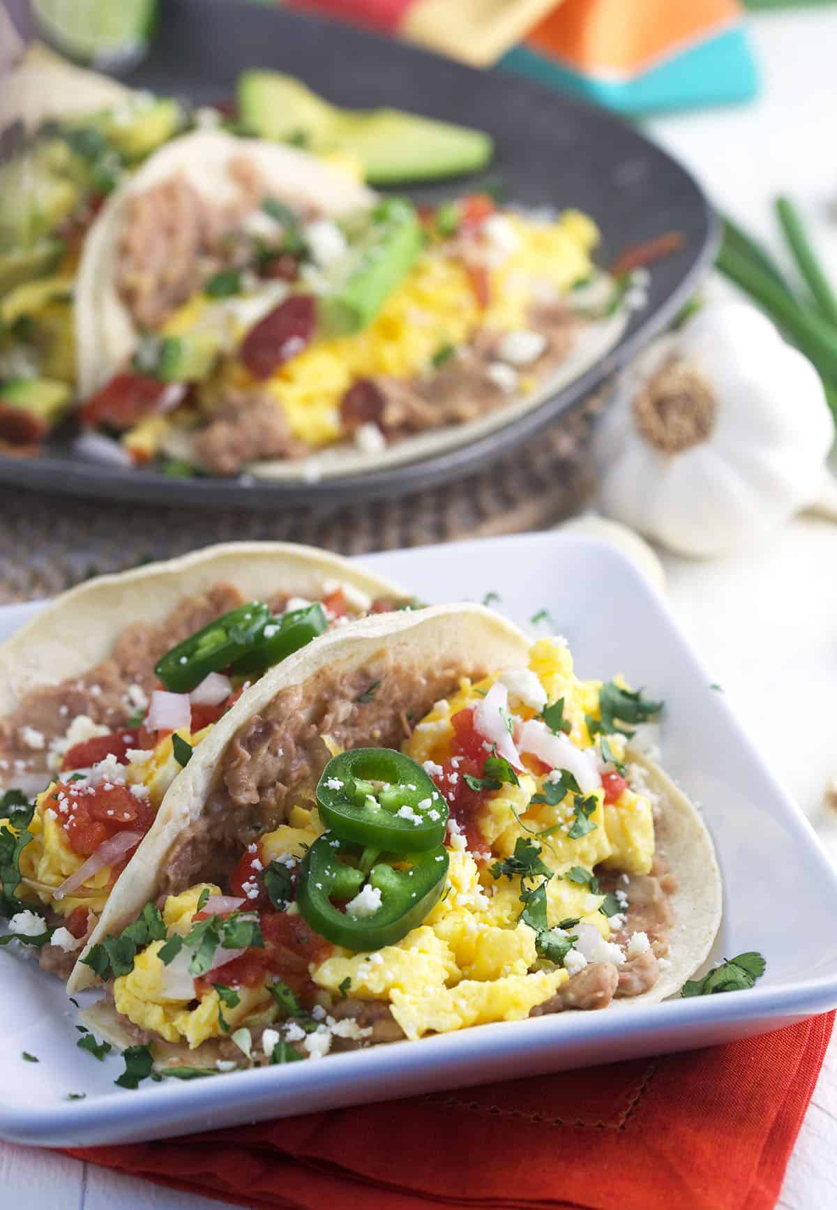 Several toppings are placed on top of a breakfast taco.