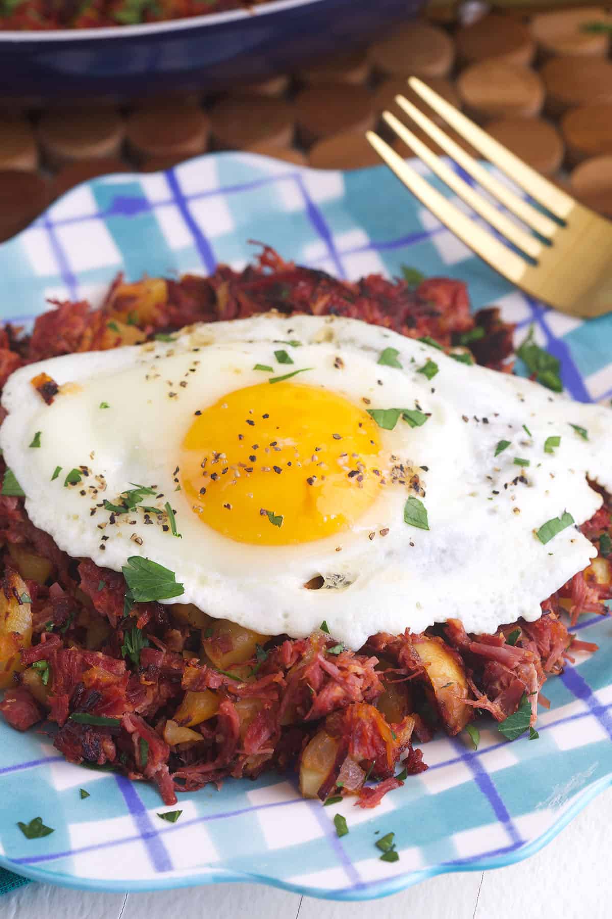 An egg is placed on top of a serving of corned beef hash. 