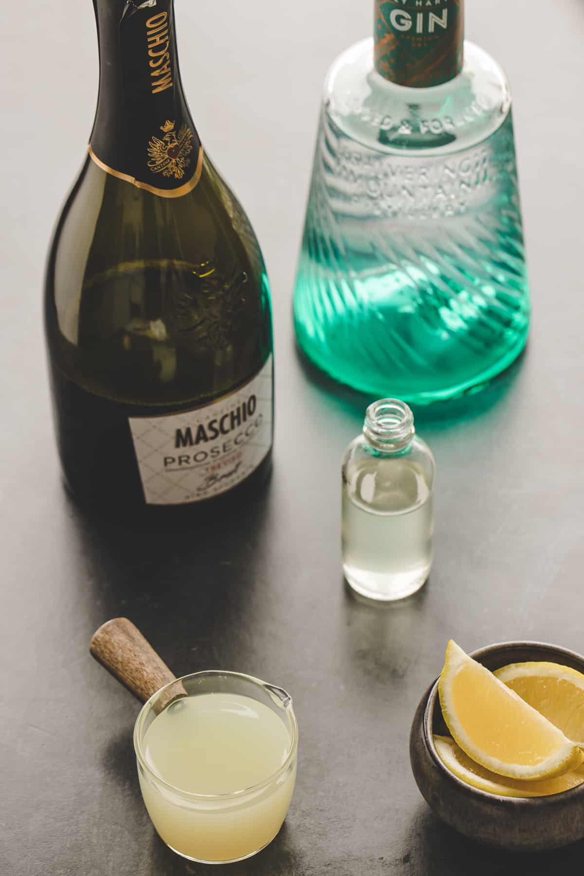 The ingredients for a french 75 are placed on a countertop. 