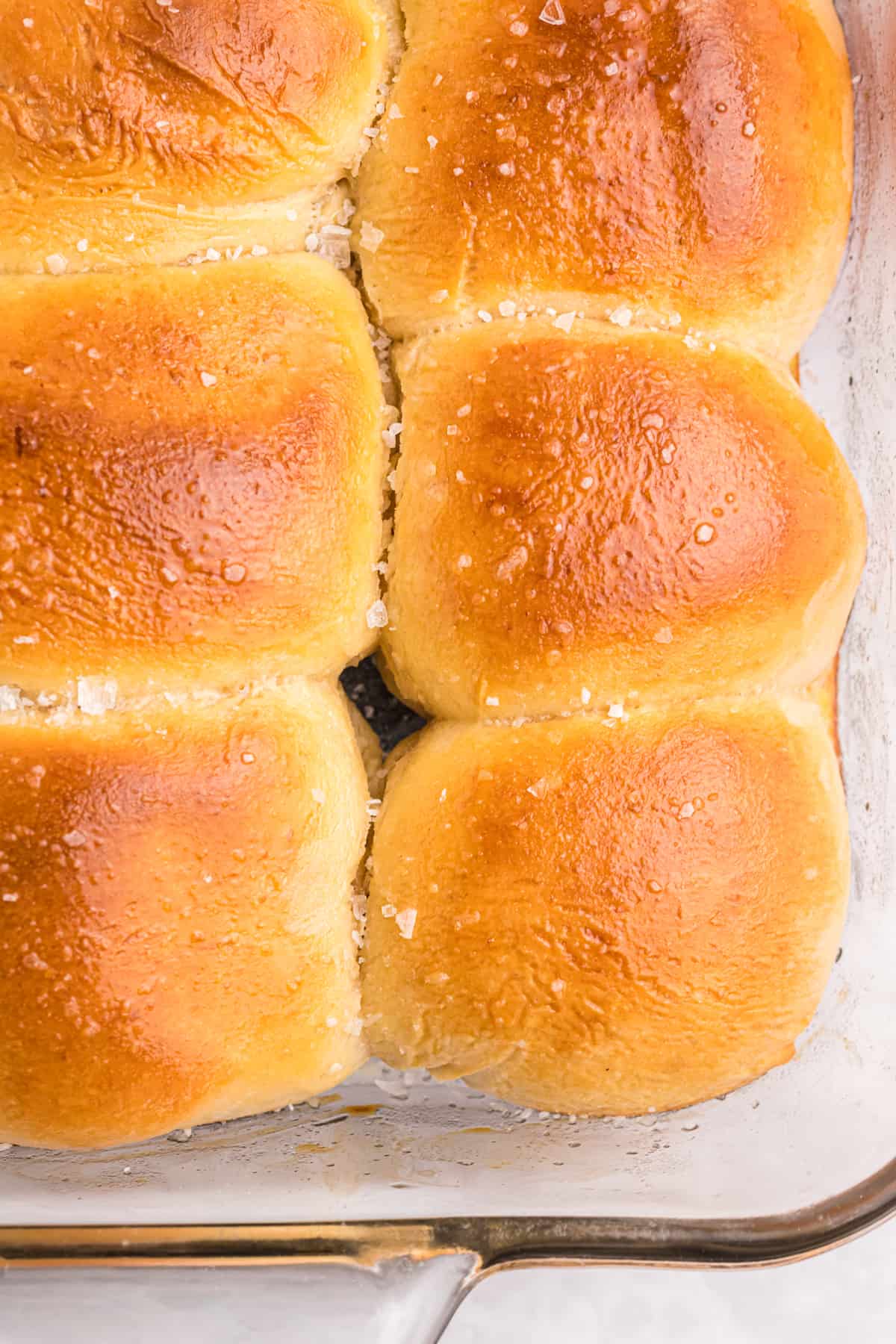 Baked rolls are golden brown and sprinkled with sea salt.