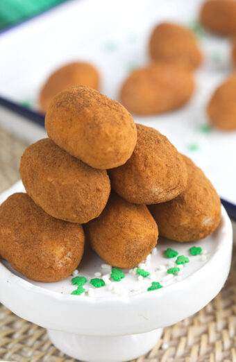 Irish potatoes are stacked in a pile on a white serving plate.