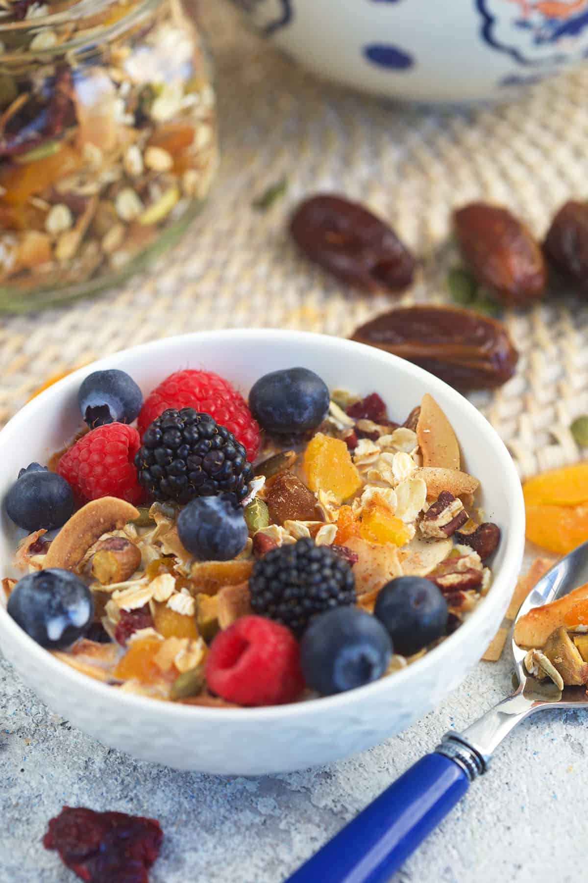 A white bowl is filled with muesli and berries.