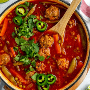A pot is filled with albondigas soup.