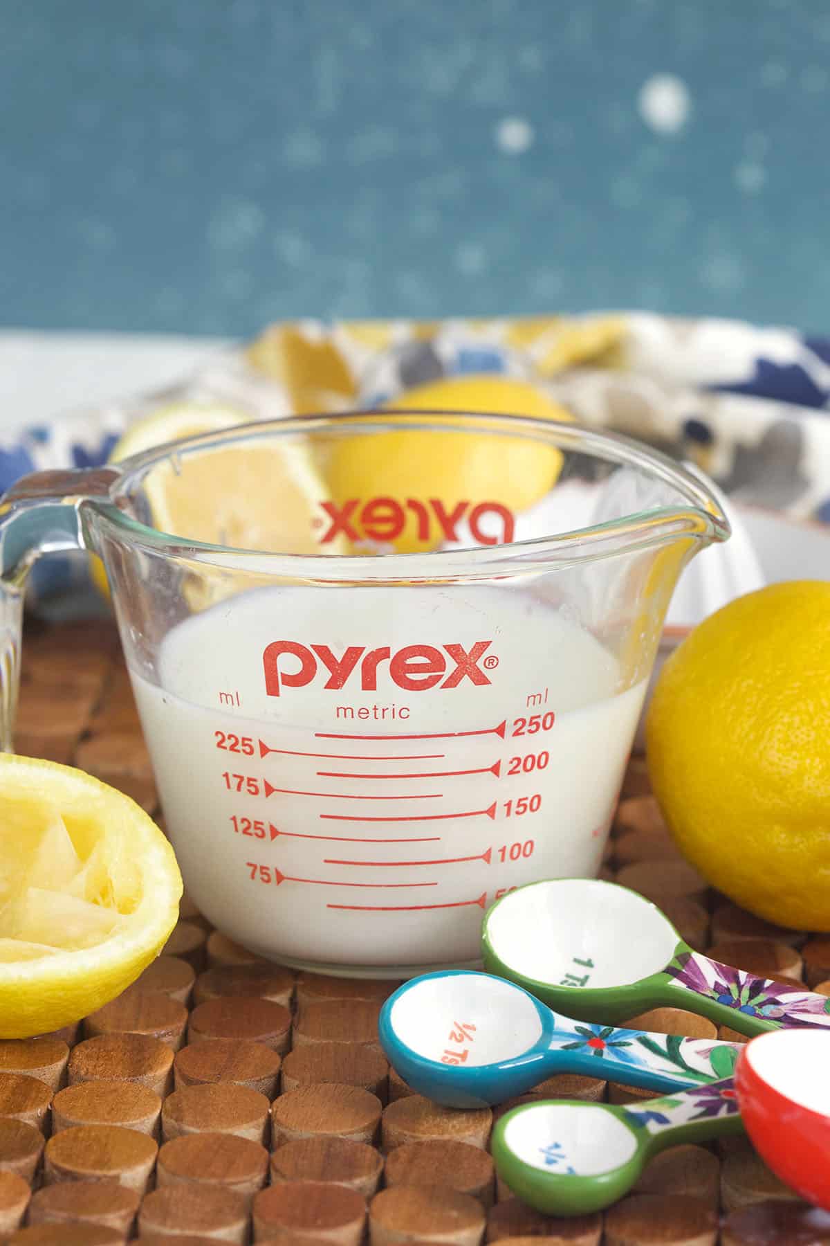 A pyrex measuring cup is filled with buttermilk. 