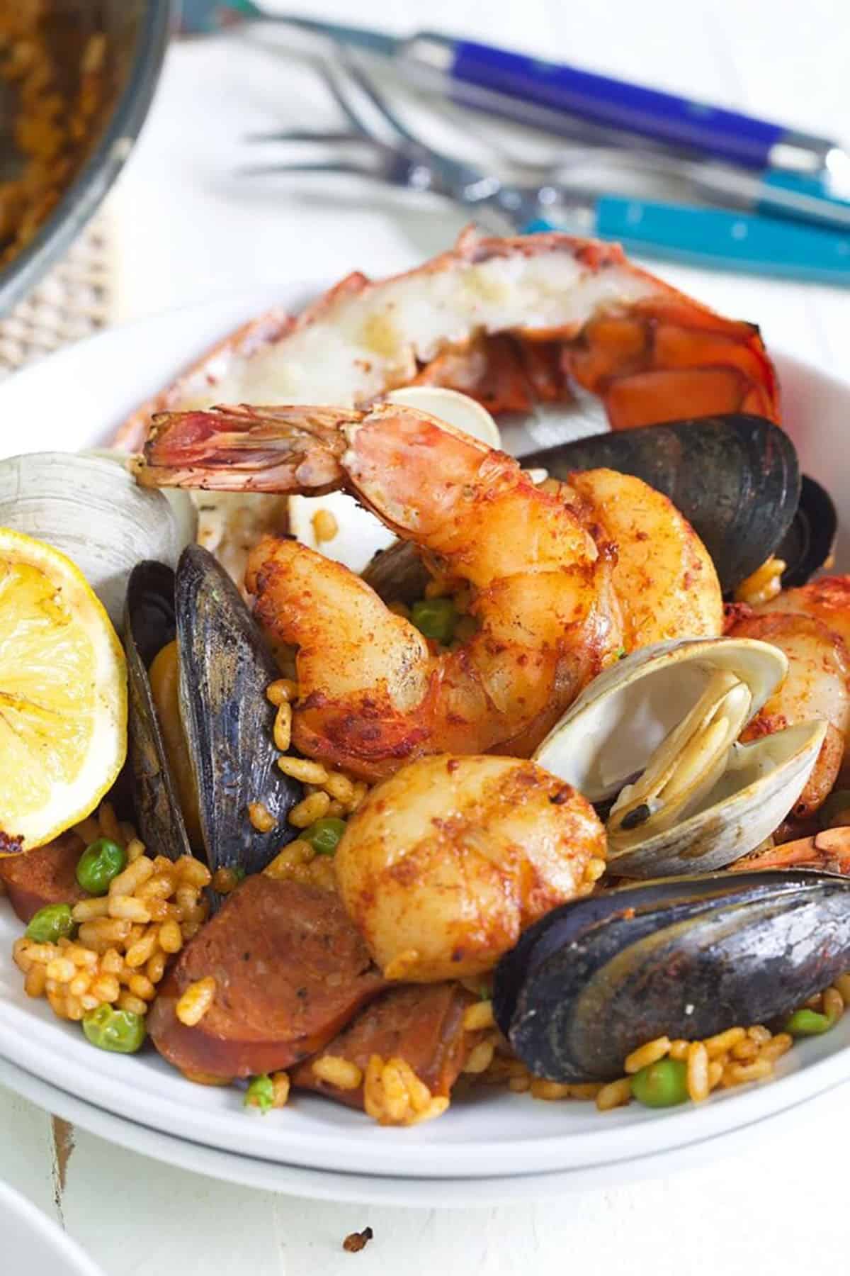 bowl of seafood paella on a white background.