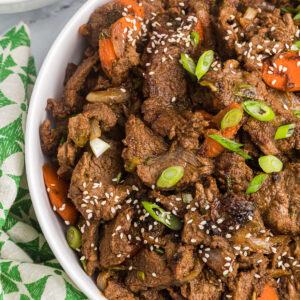 A serving of beef bulgogi is garnished with sesame seeds.