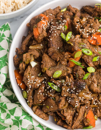 A serving of beef bulgogi is garnished with sesame seeds.