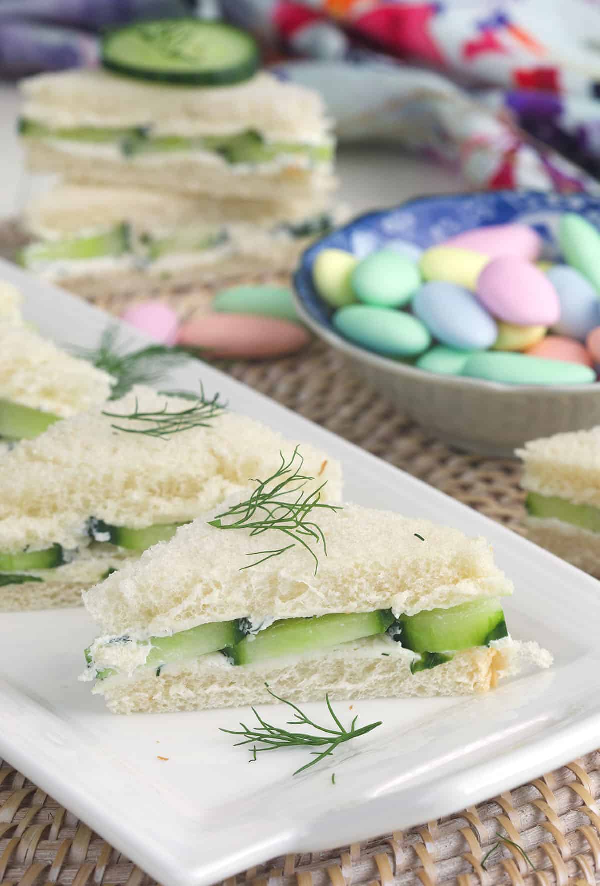 Cucumber sandwiches are garnished with fresh dill. 