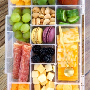 A tackle box is filled with various snacks.