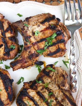 Parsley garnishes several pork chops.