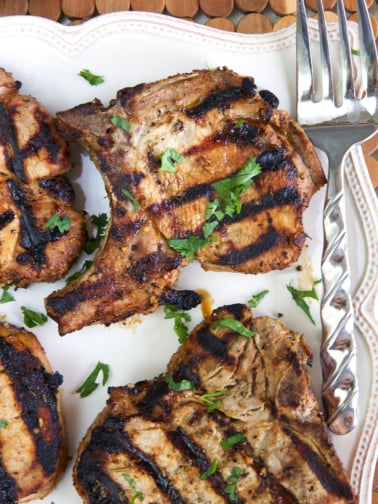 Parsley garnishes several pork chops.