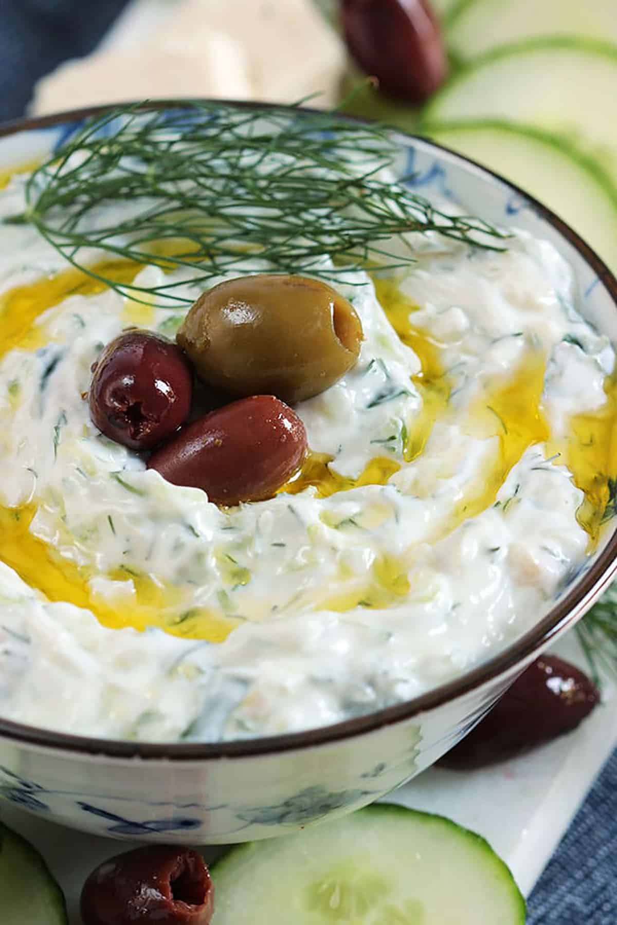 Tzatziki sauce in a bowl with olive oil drizzled on top